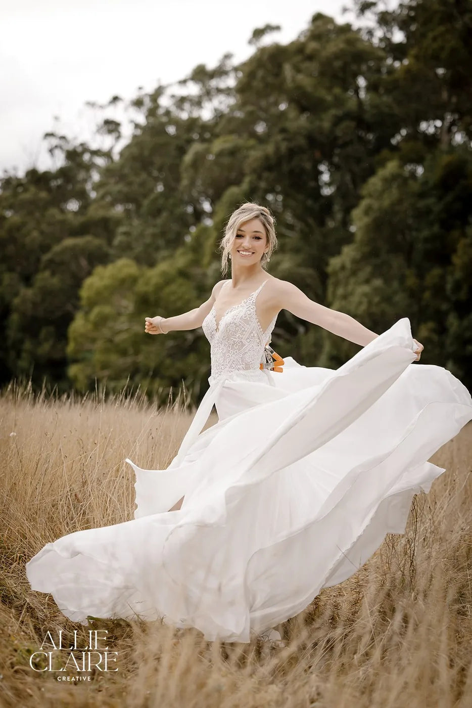 Bride in an open field, veil catching the light