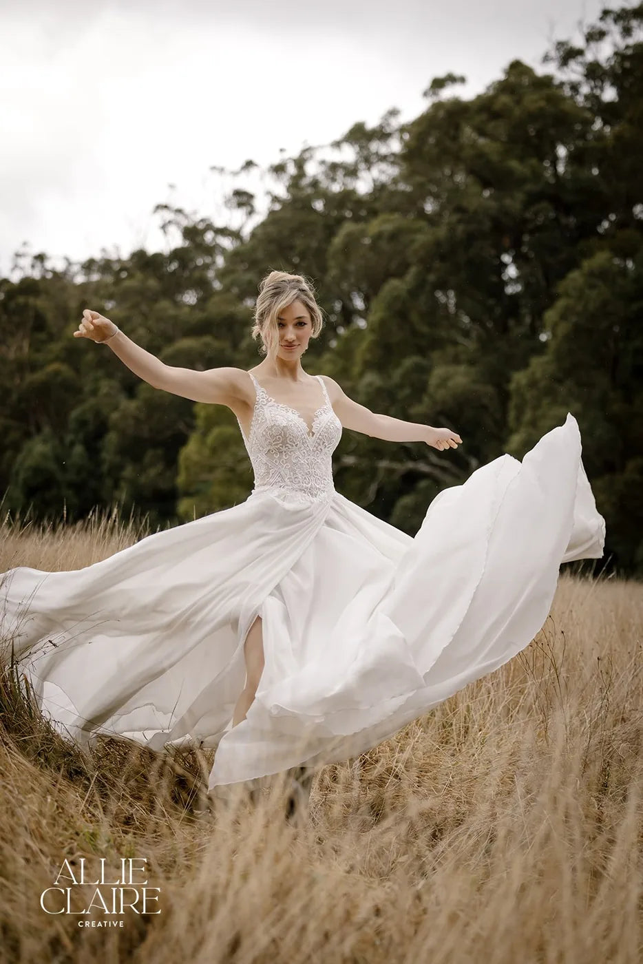 Bride turning in the long grass, skirt in motion