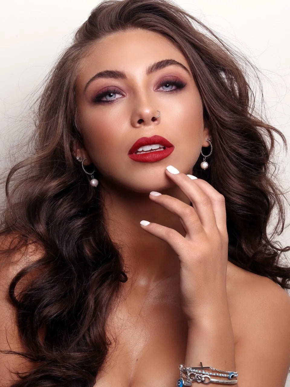 Client with a warm spray tan and a bold red lip