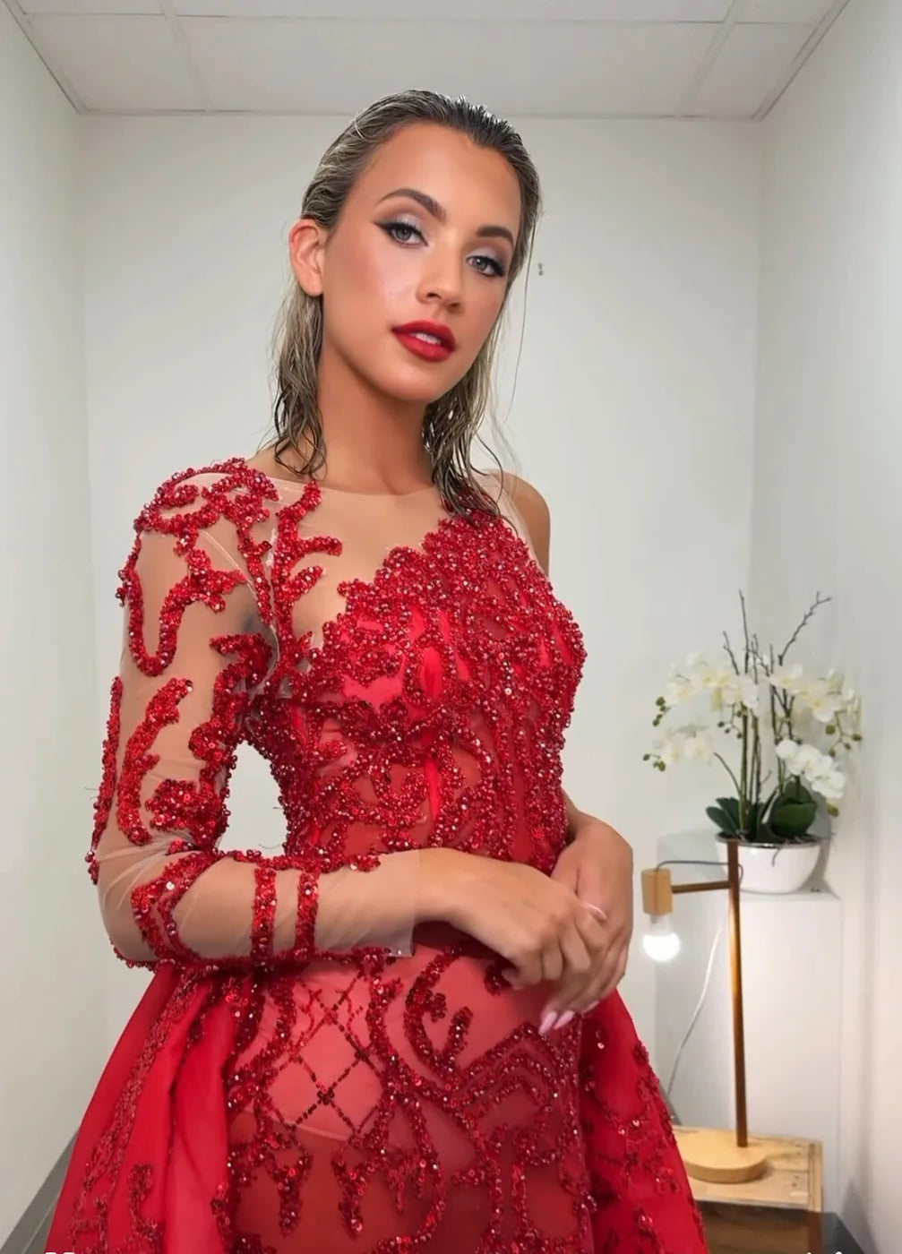 Client in a red formal gown, tanned and ready for the night